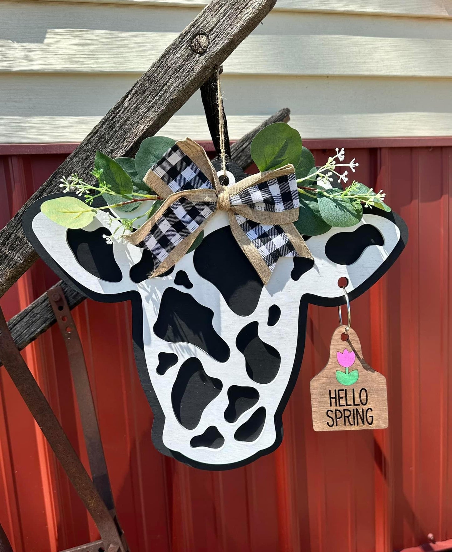 Interchangeable cow door hanger