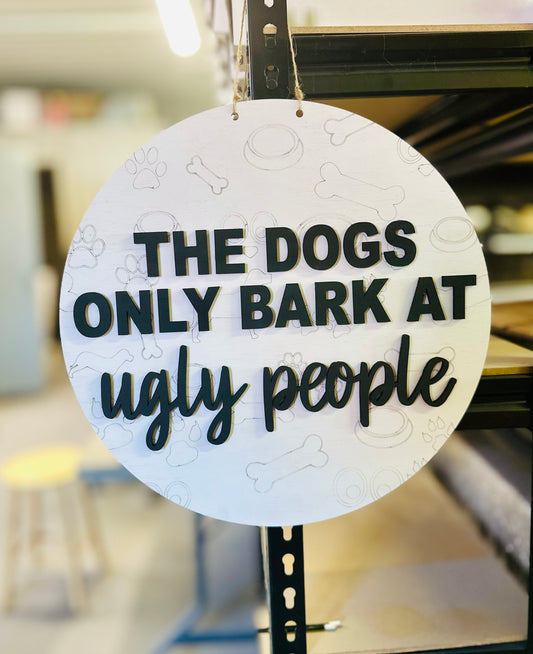 The dogs only bark at ugly people 14” door hanger